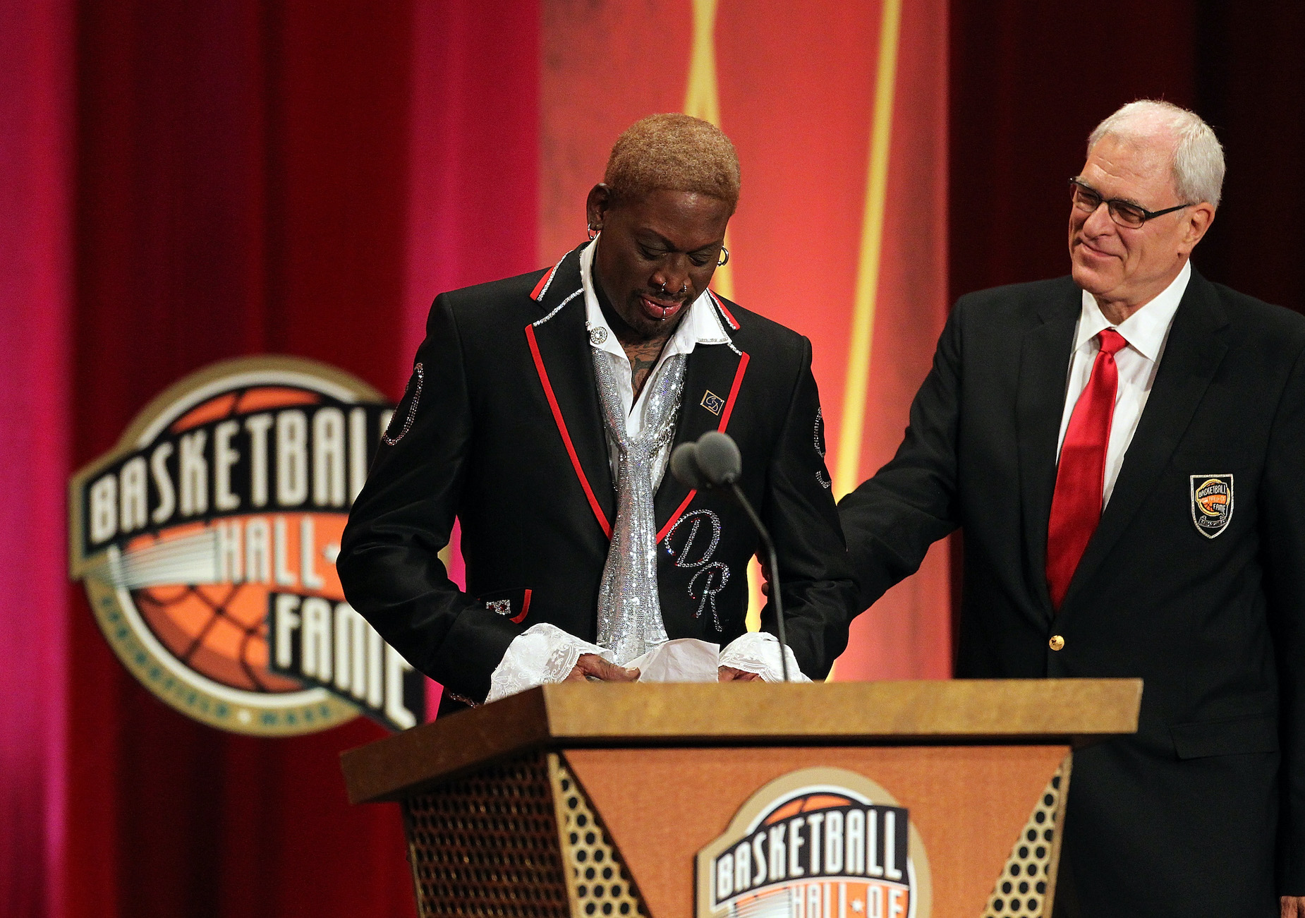 Phil Jackson (R) joins Dennis Rodman on stage during the latter's induction into the Basketball Hall of Fame.