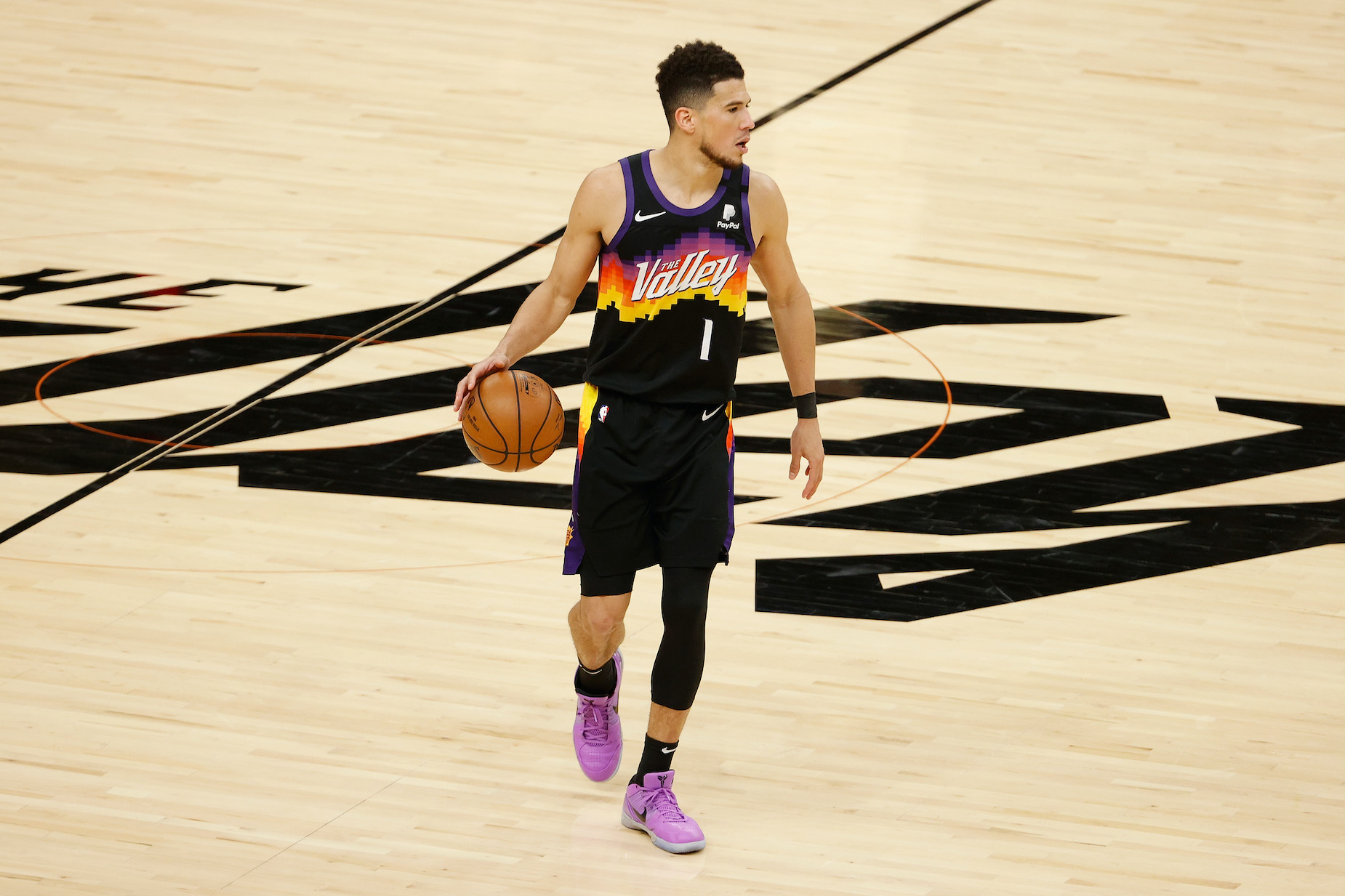 Phoenix Suns guard Devin Booker dribbles the ball during a 2021 NBA playoff game.
