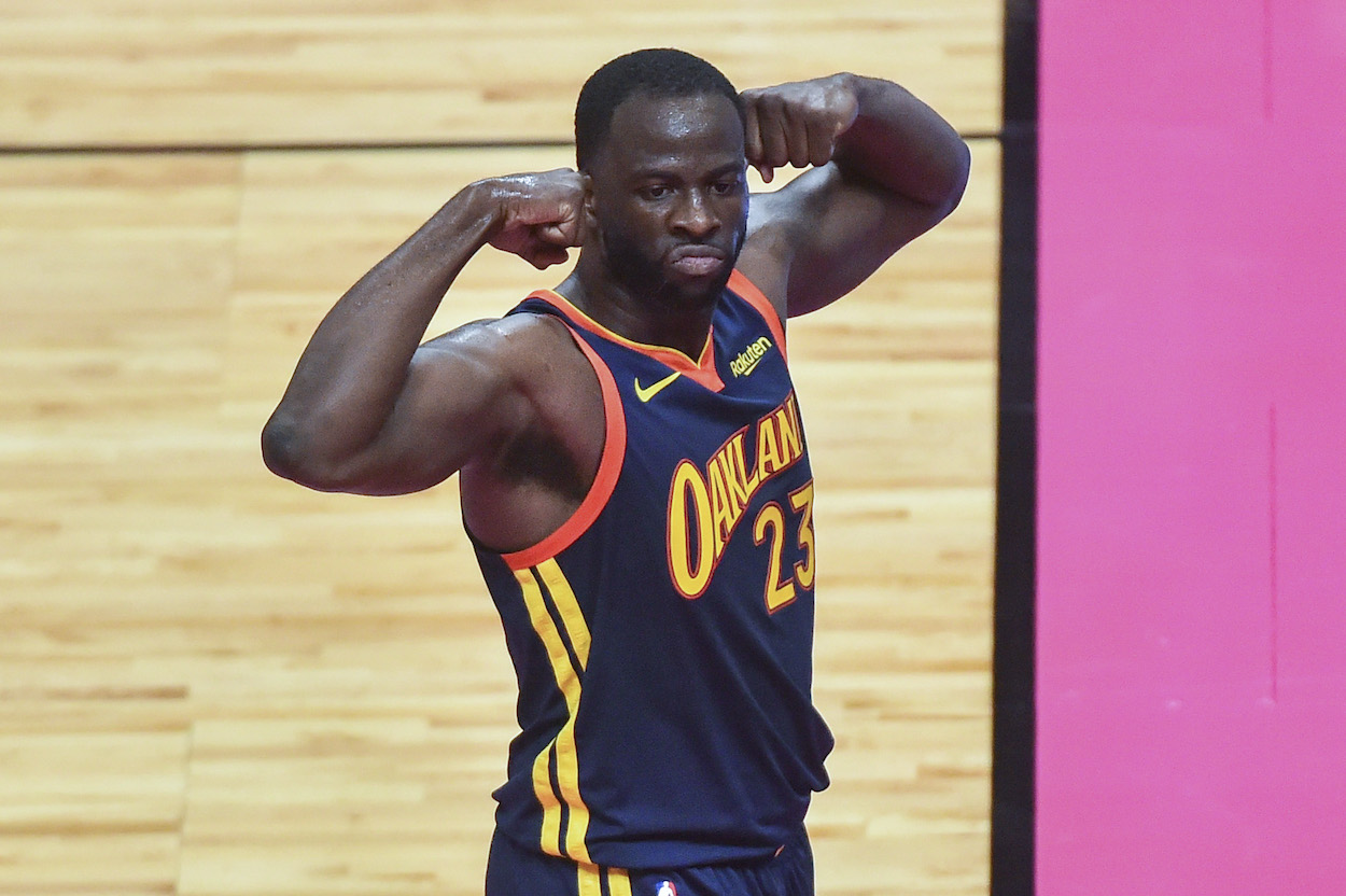 Draymond Green of the Golden State Warriors flexes after scoring a basket during the first half of the game against the Miami Heat at American Airlines Arena on April 1, 2021 in Miami, Florida.
