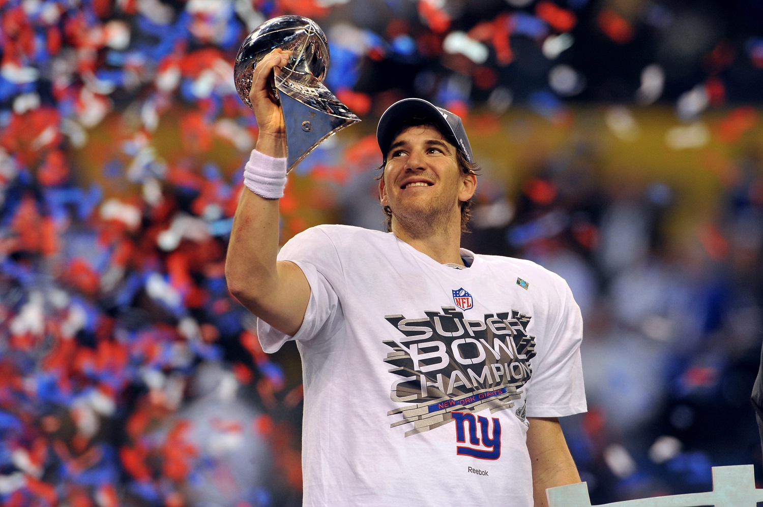 Eli Manning of the New York Giants raises the Lombardi Trophy after beating the New England Patriots in Super Bowl 46.