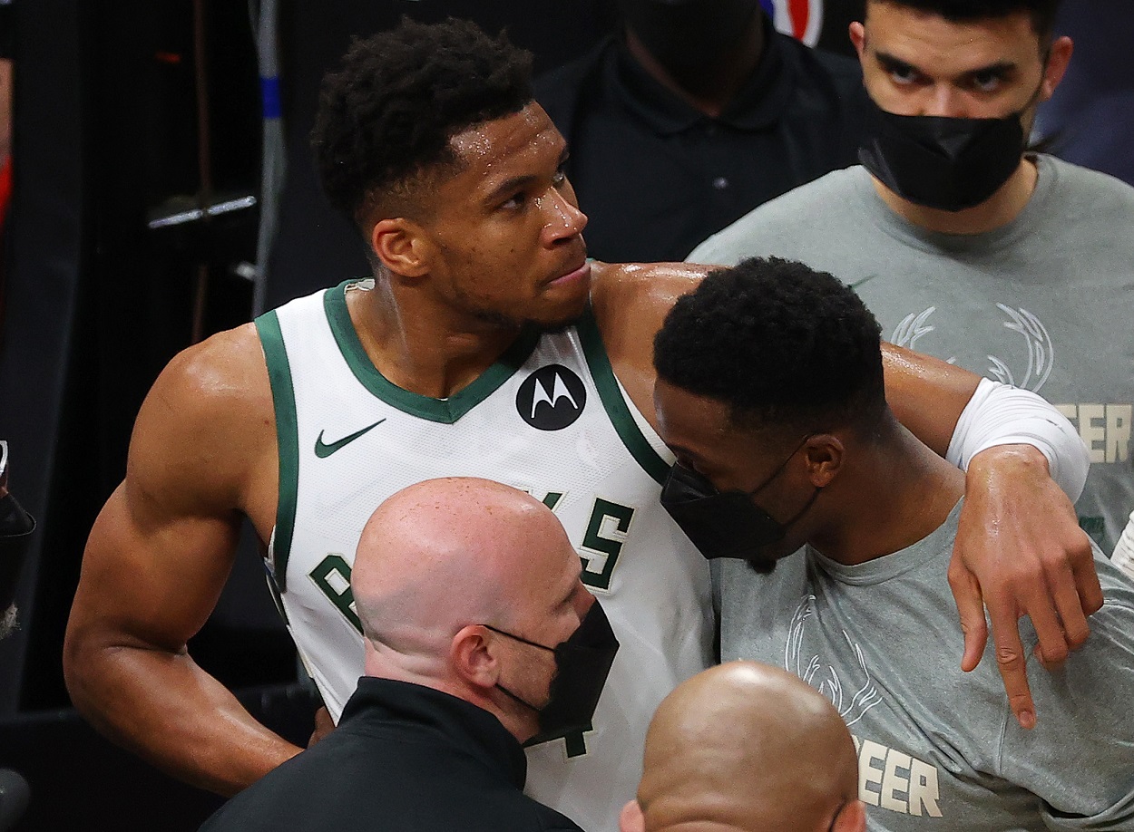Milwaukee Bucks star Giannis Antetokounmpo is helped off the floor during Game 4 of the Eastern Conference Finals after injuring his leg