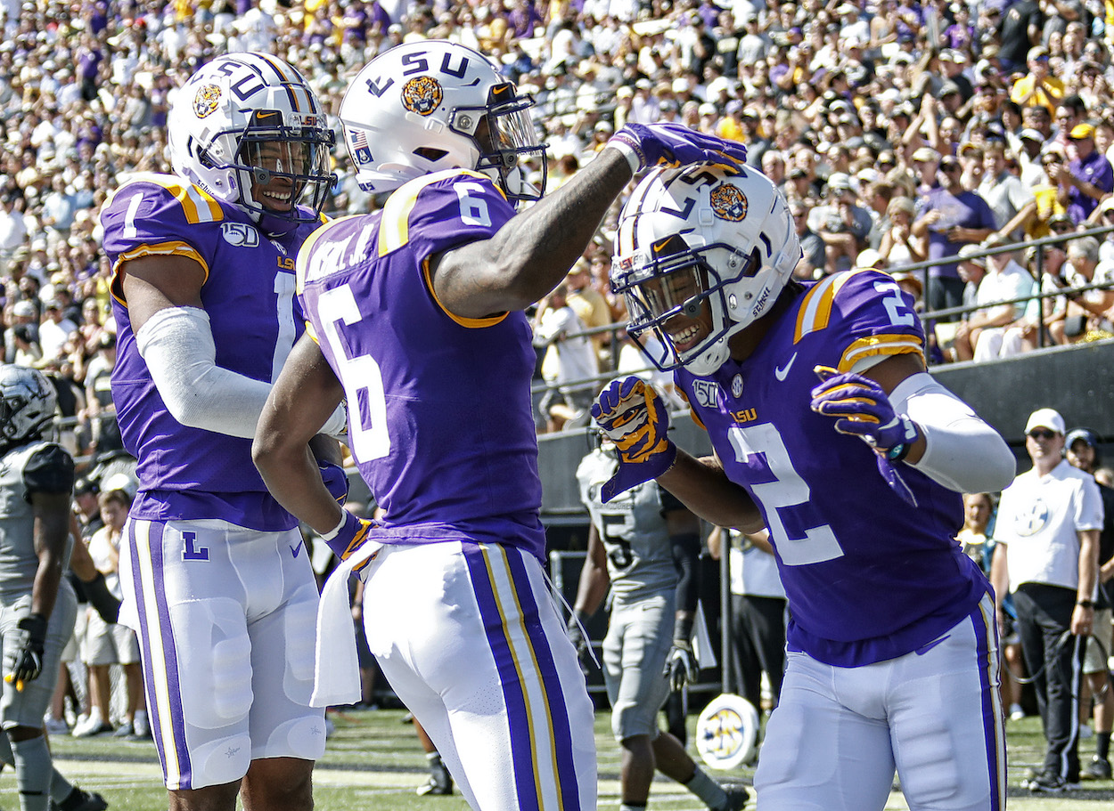 Former LSU football wide receivers Terrace Marshall Jr. and Ja'Marr Chase of the LSU Tigers congratulate teammate Justin Jefferson #2 on scoring a touchdown against the Vanderbilt Commodores during the first half at Vanderbilt Stadium on September 21, 2019.