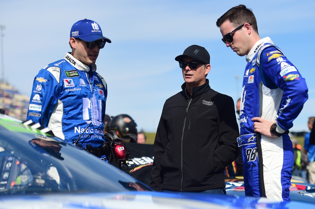 Jeff Gordon, center, talks with Alex Bowman, right, and crew chief Greg Ives.