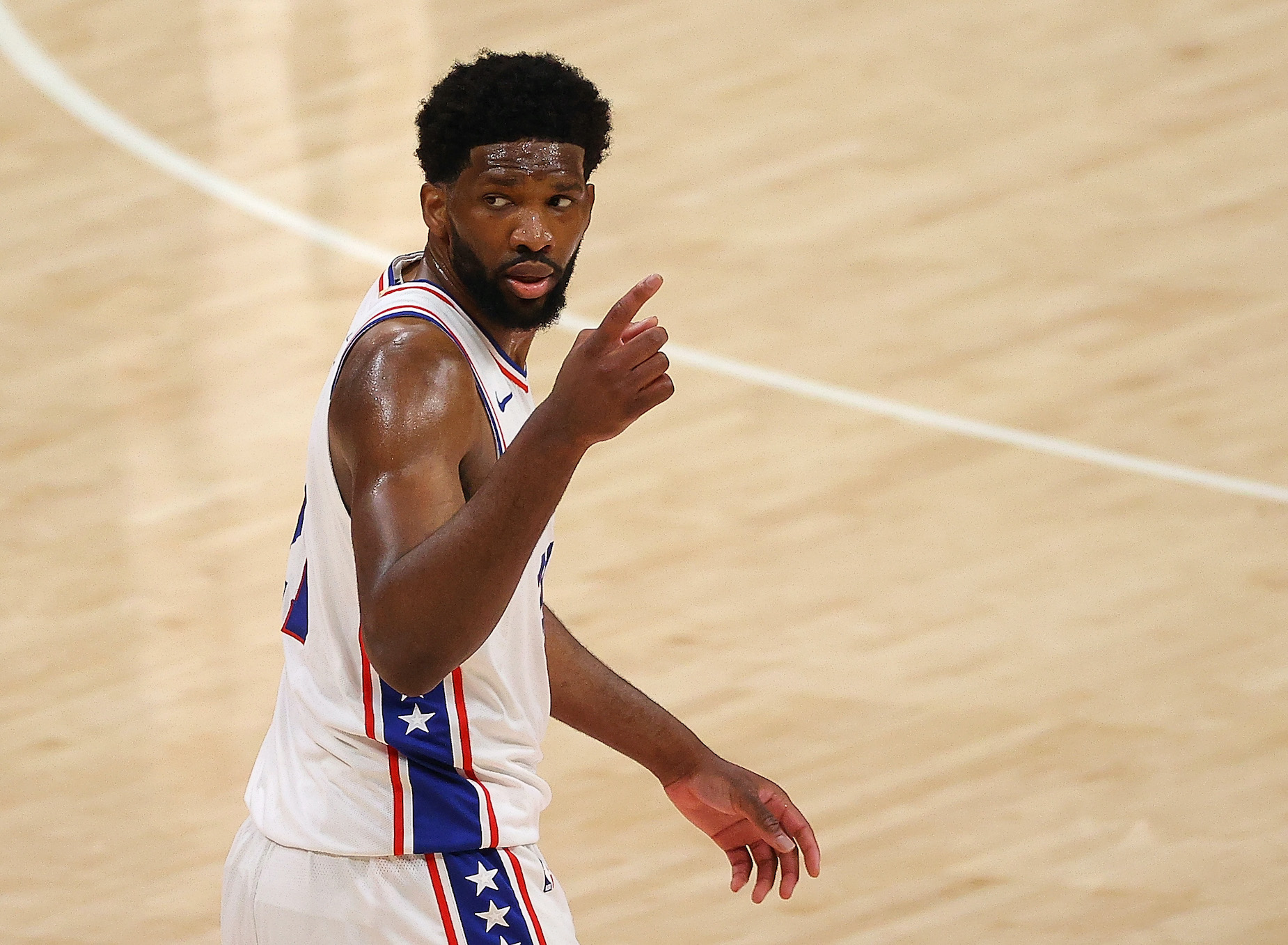 Joel Embiid gestures on the court during a Philadelphia 76ers playoff game.