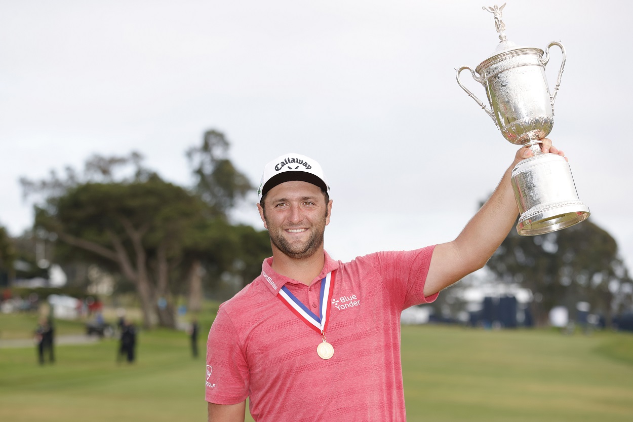 Jon Rahm holds up the U.S. Open trophy after winning his first major championship