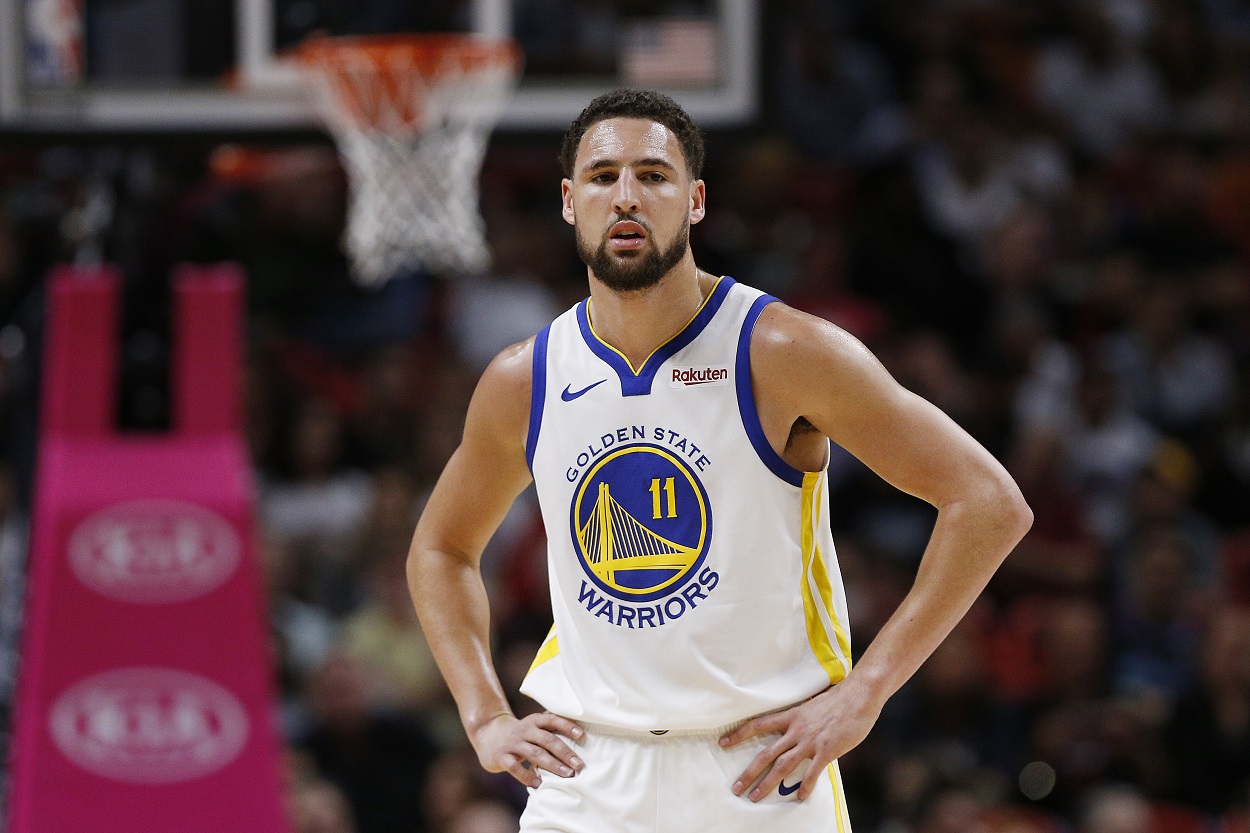 Warriors guard Klay Thompson reacts to a play during an NBA game.