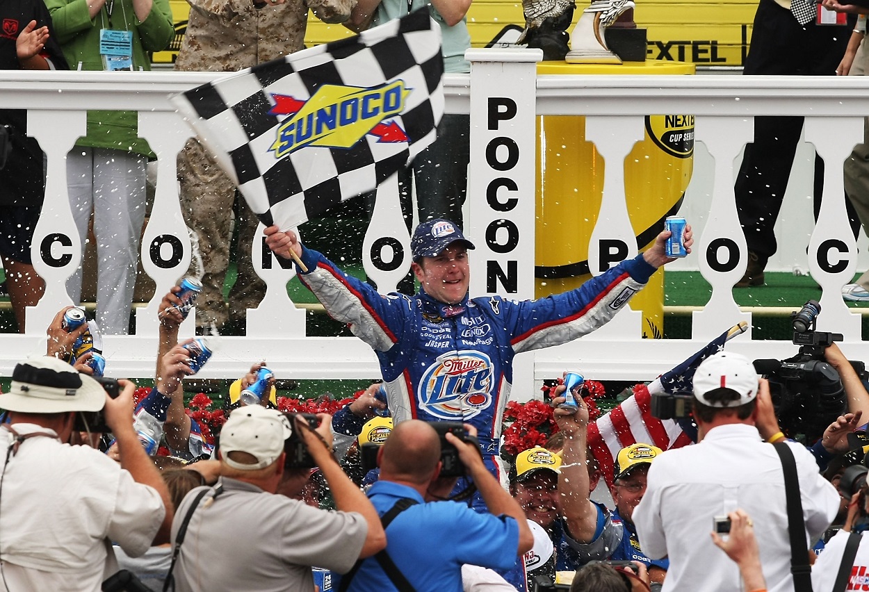 Kurt Busch celebrates after winning the 2007 NASCAR Cup Series Pennsylvania 500 at Pocono Raceway