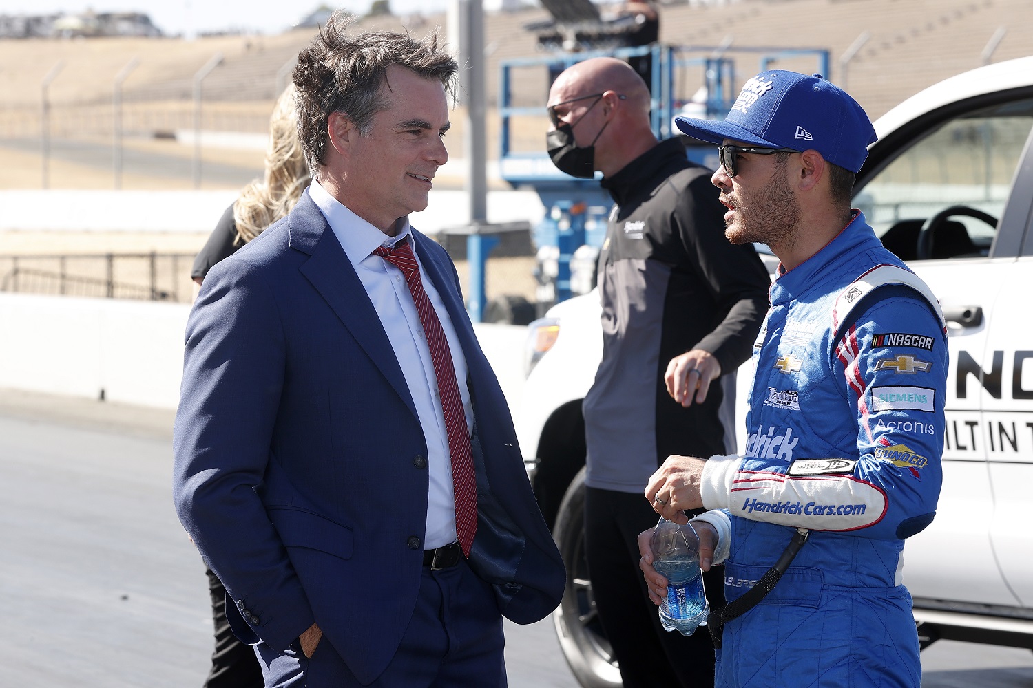 Kyle Larson, driver of the Hendrick Motorsports No. 5 Chevrolet, talks with Hall of Fame driver and TV commentator Jeff Gordon after winning the NASCAR Cup Series Toyota/Save Mart 350 at Sonoma Raceway on June 6, 2021.