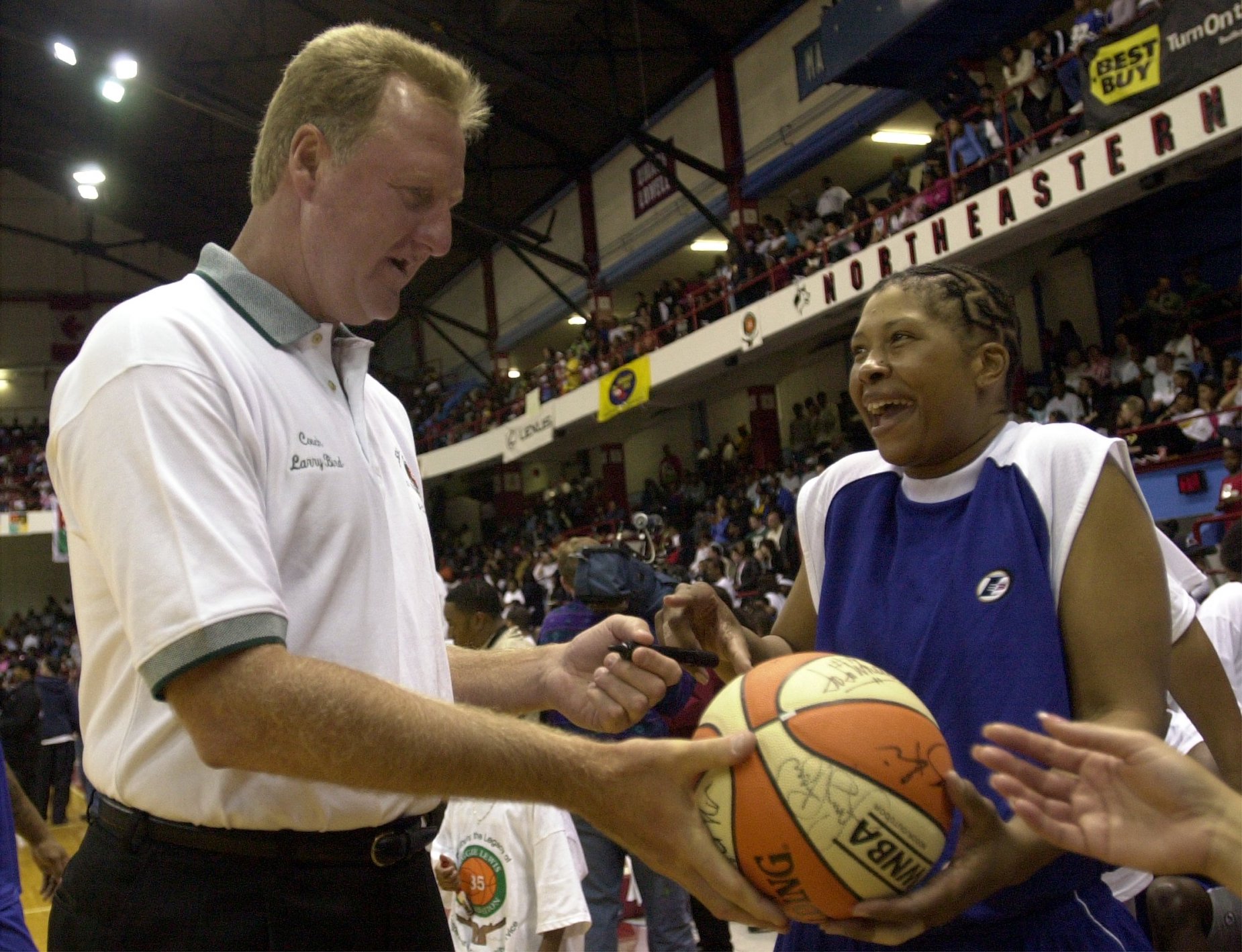 Boston Celtics great Larry Bird signs an autograph at the 2001 Celebrity Basketball Challenge