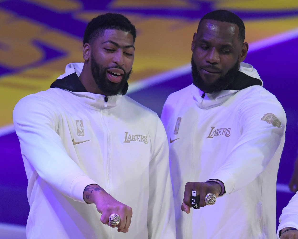 LeBron James and Anthony Davis of the Los Angeles Lakers pose with their rings during the 2020 NBA championship ring ceremony before their opening night game against the Los Angeles Clippers at Staples Center on December 22, 2020 in Los Angeles, California.