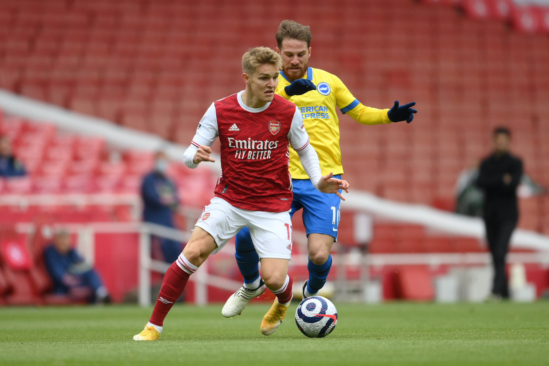 Martin Ødegaard dribbles past a Brighton defender during his time on loan at Arsenal