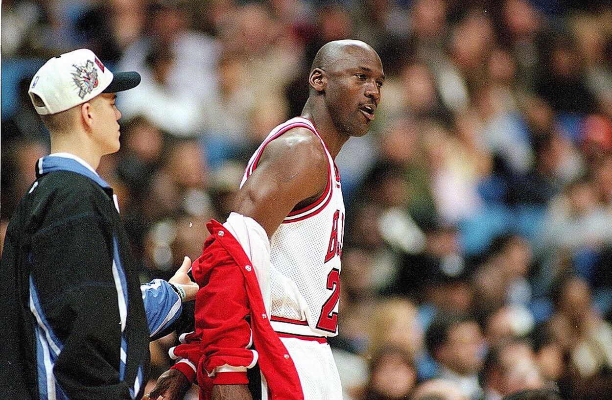 Michael Jordan removes his warm-up jacket during the 1997 NBA All-Star Game.