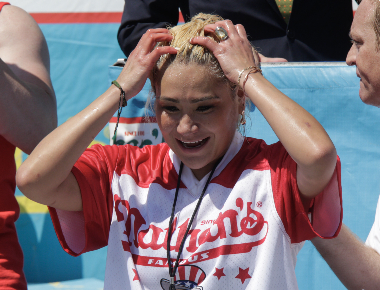 Miki Sudo reacts after winning the Nathan's Hot Dog Eating Contest in 2019
