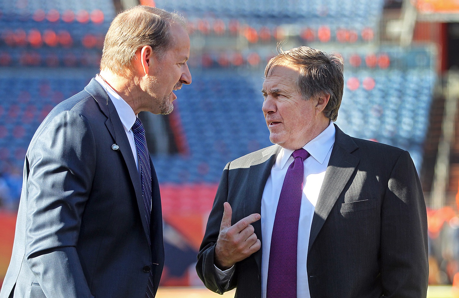 Former Pittsburgh Steelers head coach Bill Cowher talks with New England Patriots head coach Bill Belichick before the AFC championship game in Denver on ,Jan. 24, 2016.