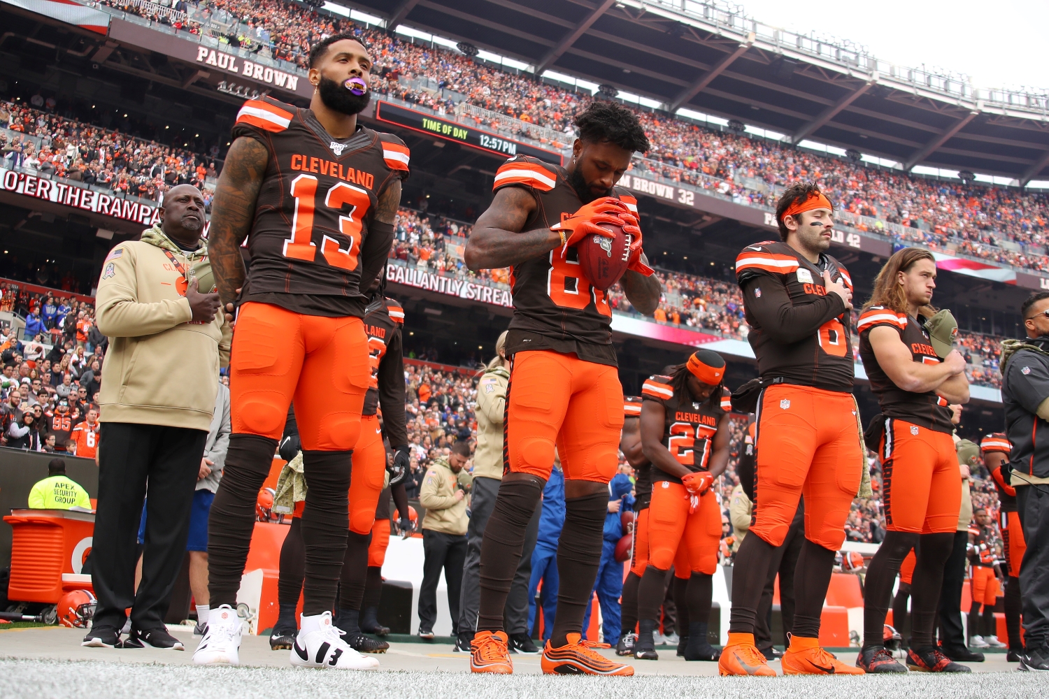 Cleveland Browns players Odell Beckham, Jarvis Landry, and Baker Mayfield stand for the National Anthem prior to a game.