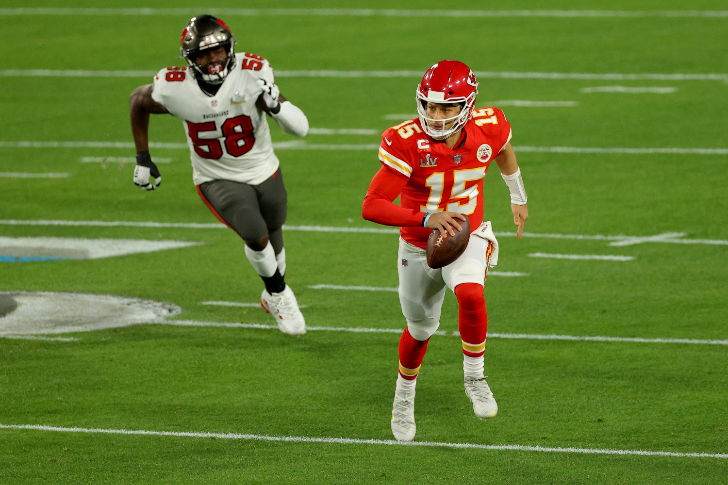 Kansas City Chiefs quarterback Patrick Mahomes runs away from a Tampa Bay Buccaneers defender during the Super Bowl.