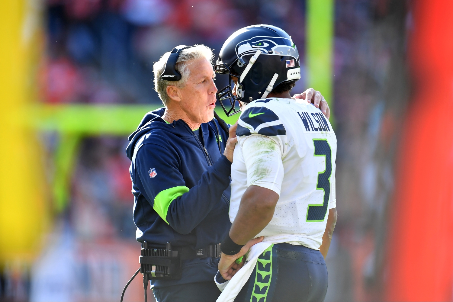 Seattle Seahawks head coach Pete Carroll talks to Russell Wilson during a game.