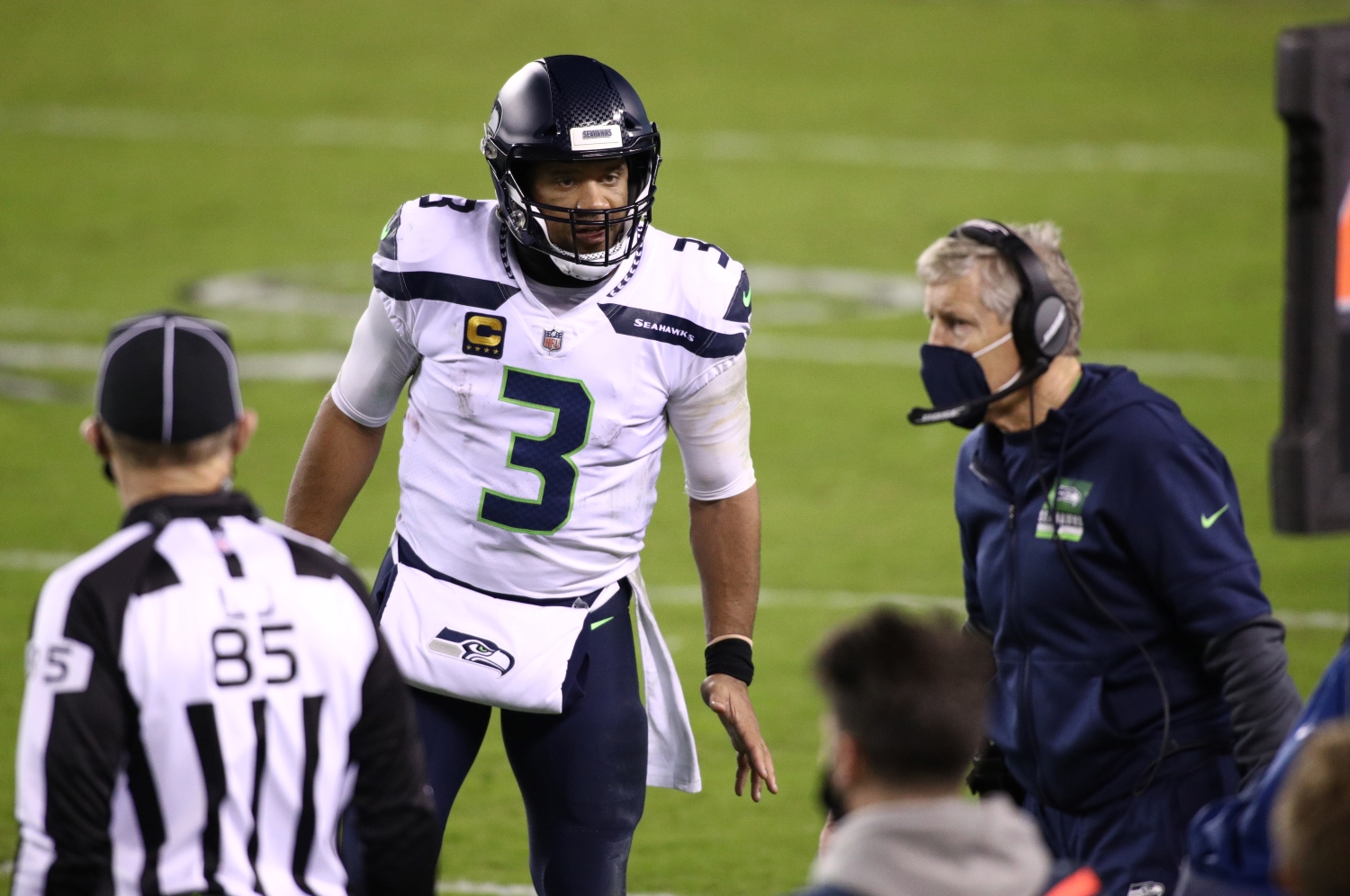 Russell Wilson speaks to Seattle Seahawks coach Pete Carroll during a game.