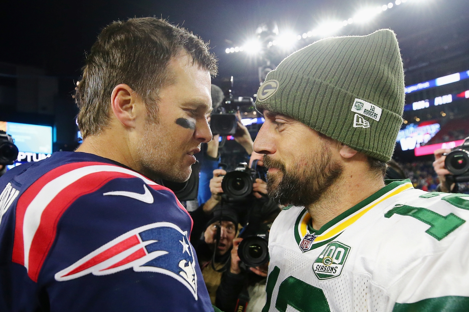 Tom Brady speaks to Aaron Rodgers after a game between the New England Patriots and the Green Bay Packers.