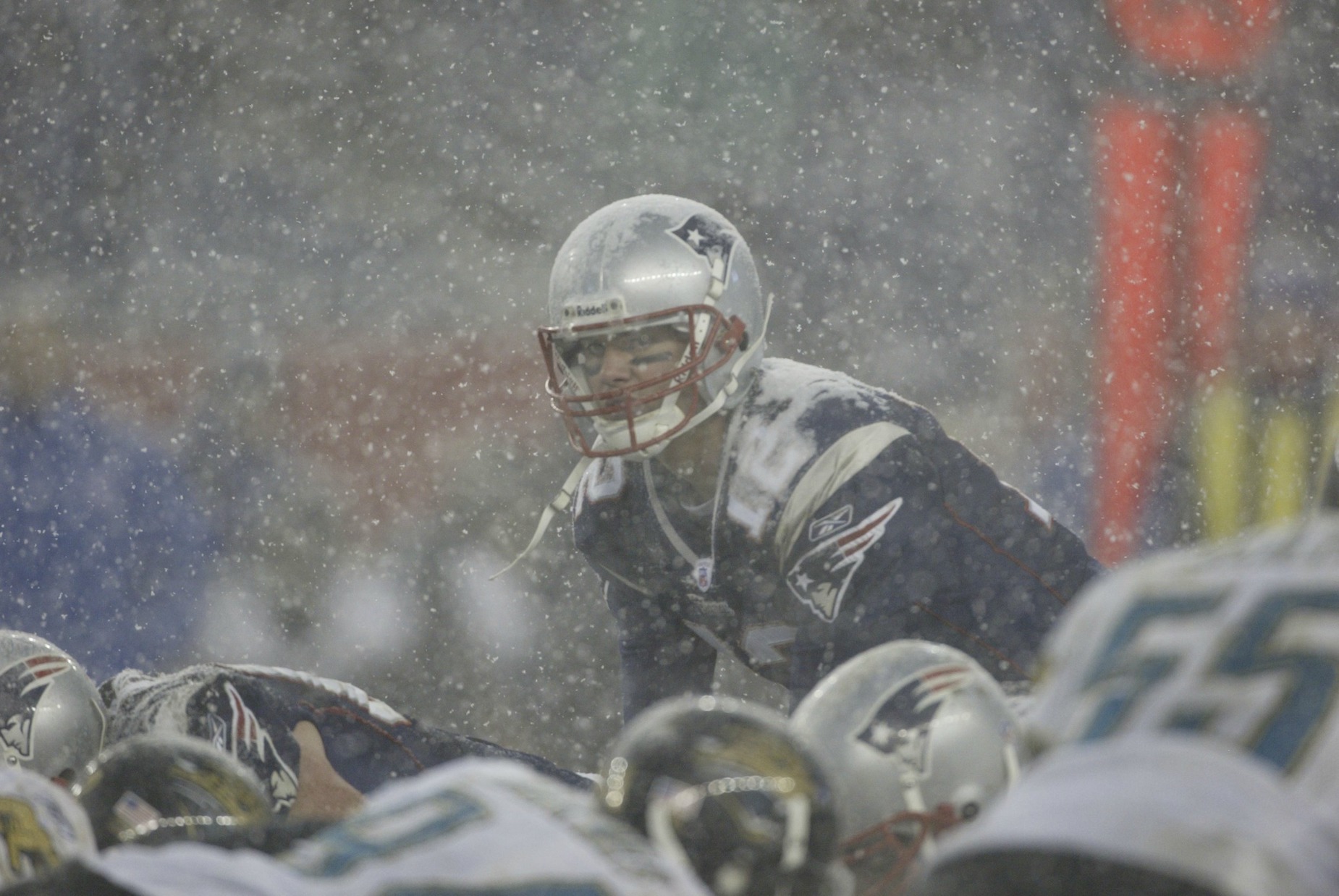 Tom Brady lines up under center in the snow.
