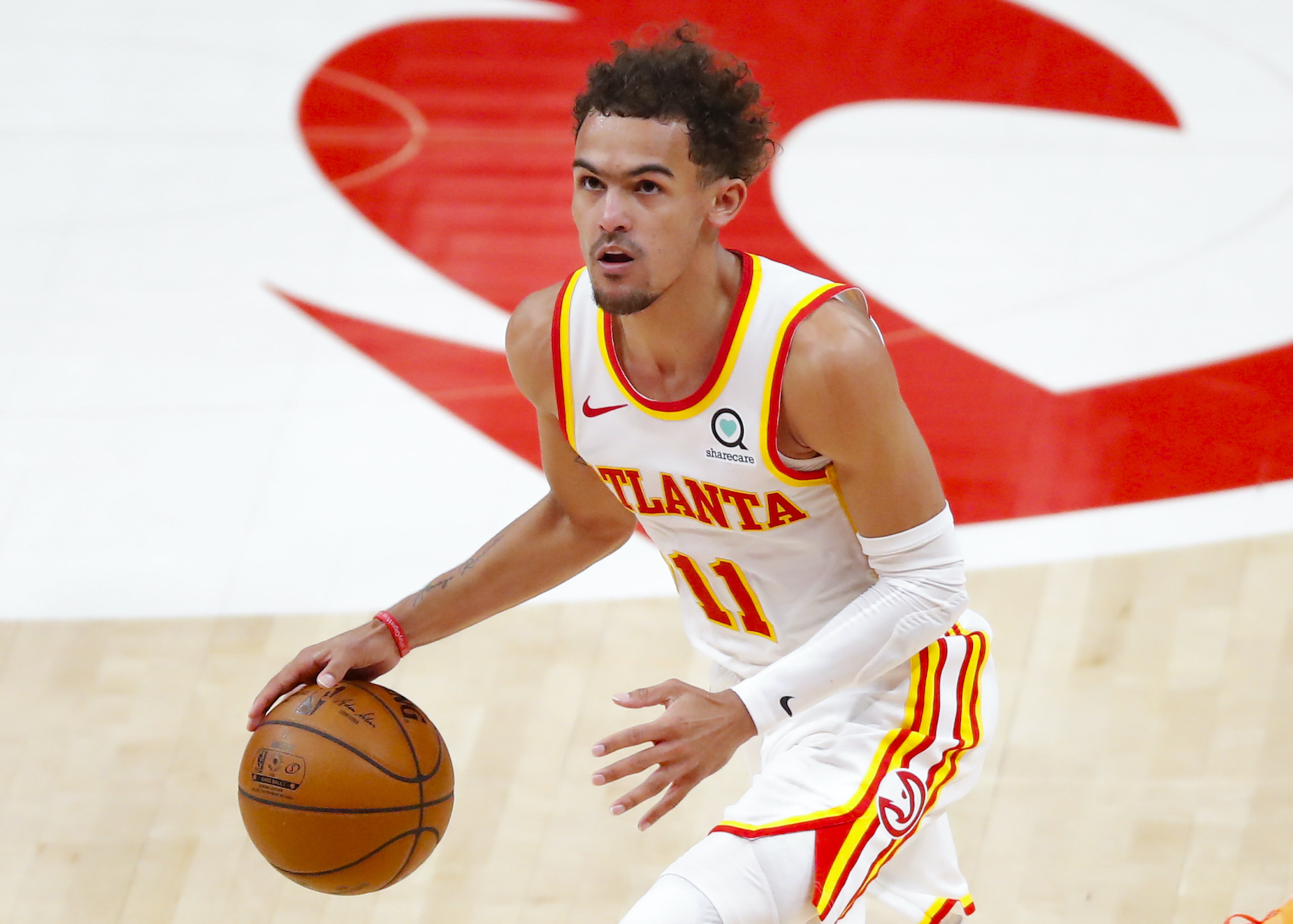 Atlanta Hawks guard Trae Young dribbles the ball up the court.