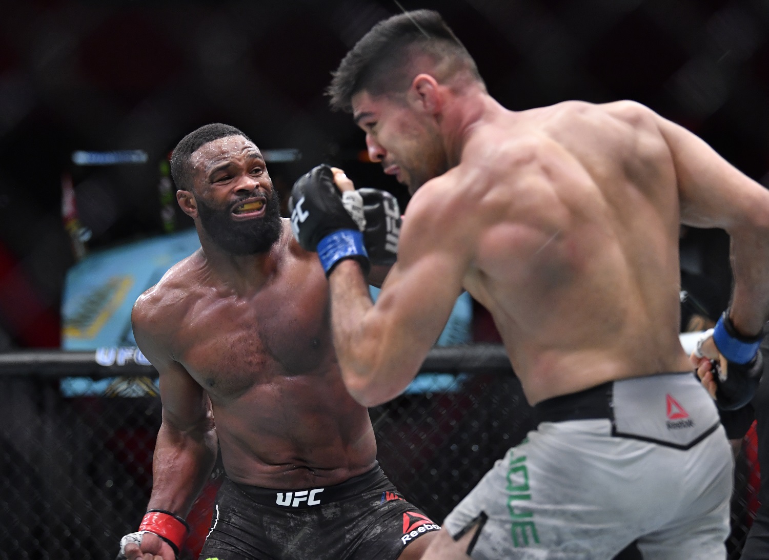 Tyron Woodley, left, punches Vicente Luque in their welterweight fight during the UFC 260 event on March 27, 2021 in Las Vegas.