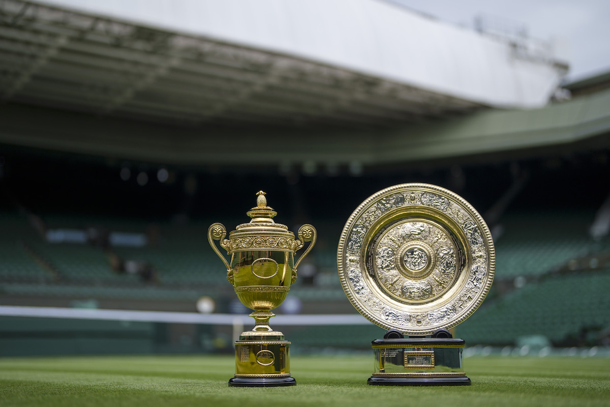 The Ladies' Singles Trophy, the Venus Rosewater Dish, and the Men's Singles Trophy are photographed on center court before Wimbledon 2021