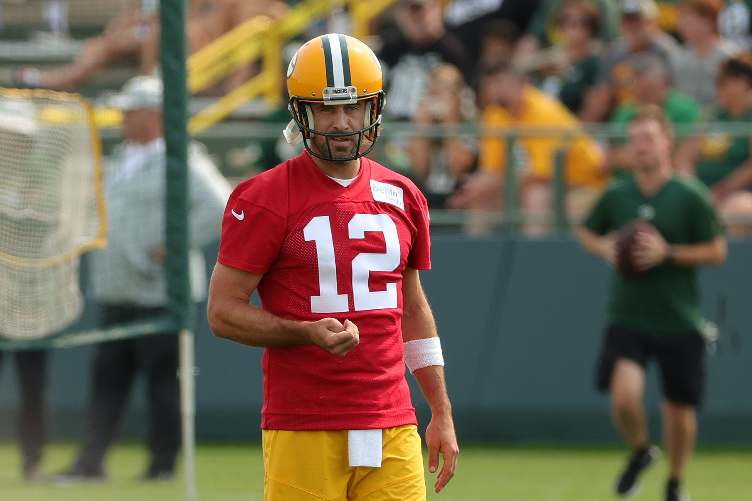 Aaron Rodgers of the Green Bay Packers works out during training camp .