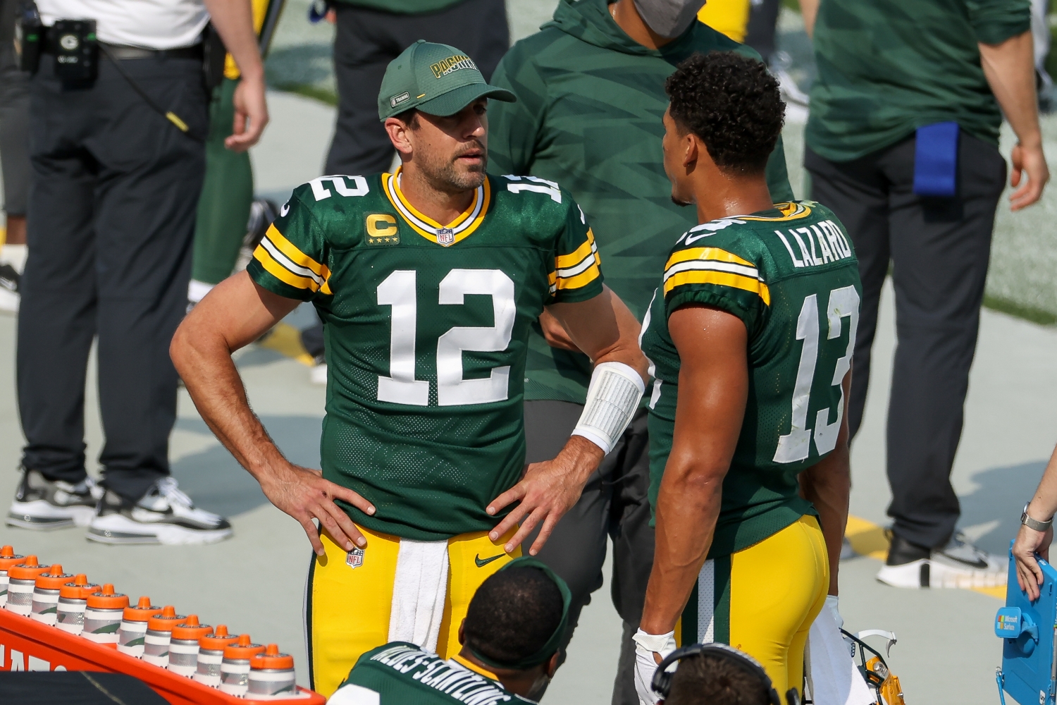 Green Bay Packers teammates Aaron Rodgers and Allen Lazard speak on the sideline.