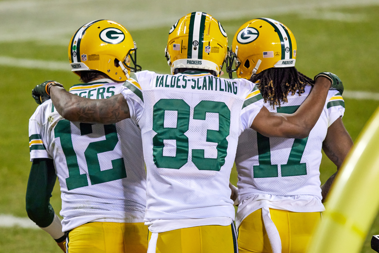 Green Bay Packers wide receiver Davante Adams (17) celebrates with wide receiver Marquez Valdes-Scantling (83) and quarterback Aaron Rodgers (12) after scoring a touchdown .