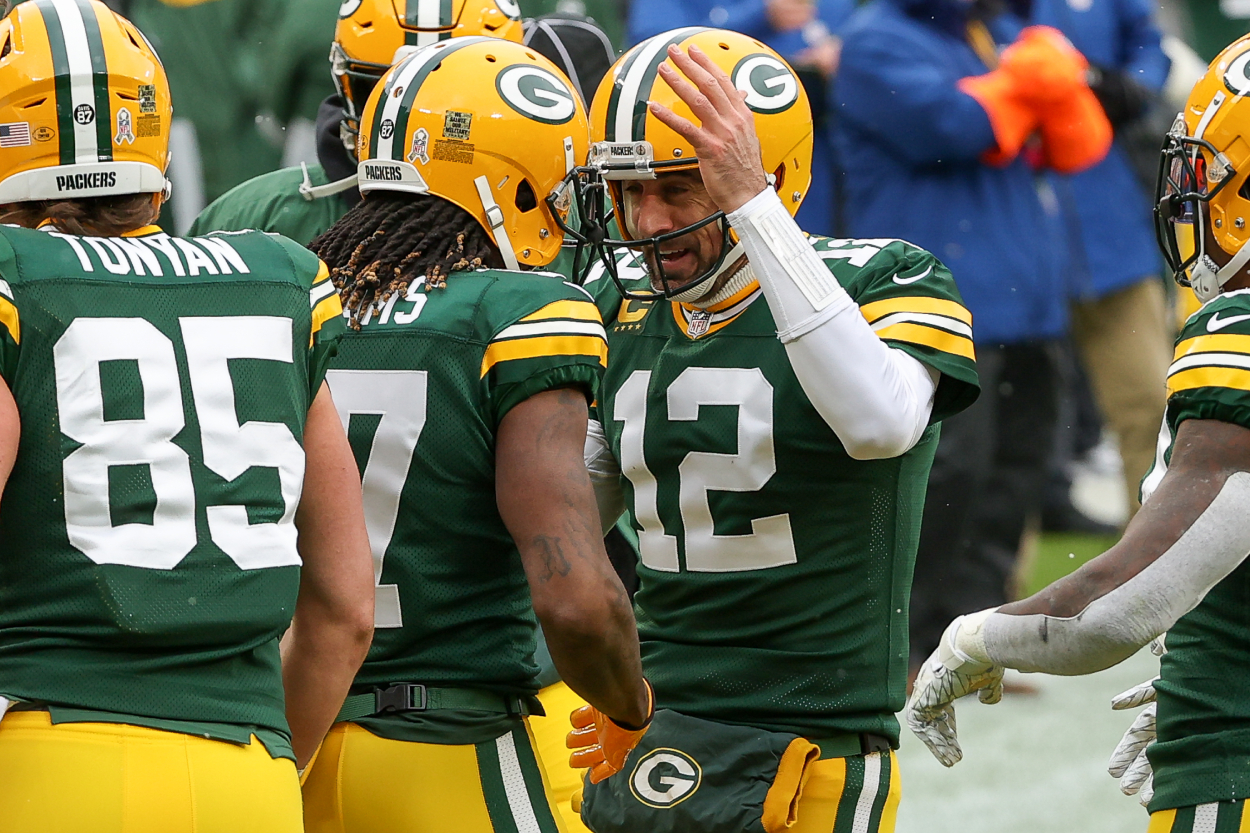 Davante Adams #17 and Aaron Rodgers #12 of the Green Bay Packers celebrate a touchdown.