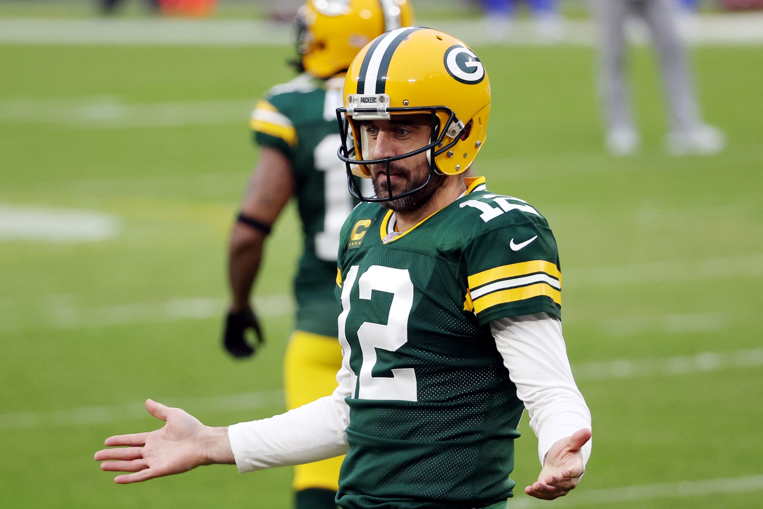 Green Bay Packers quarterback Aaron Rodgers motions to the sideline before a game.
