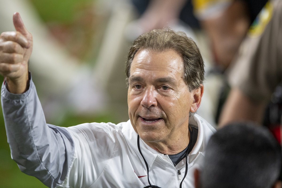 Alabama Crimson Tide head coach Nick Saban smiles and gives a thumbs up to fans