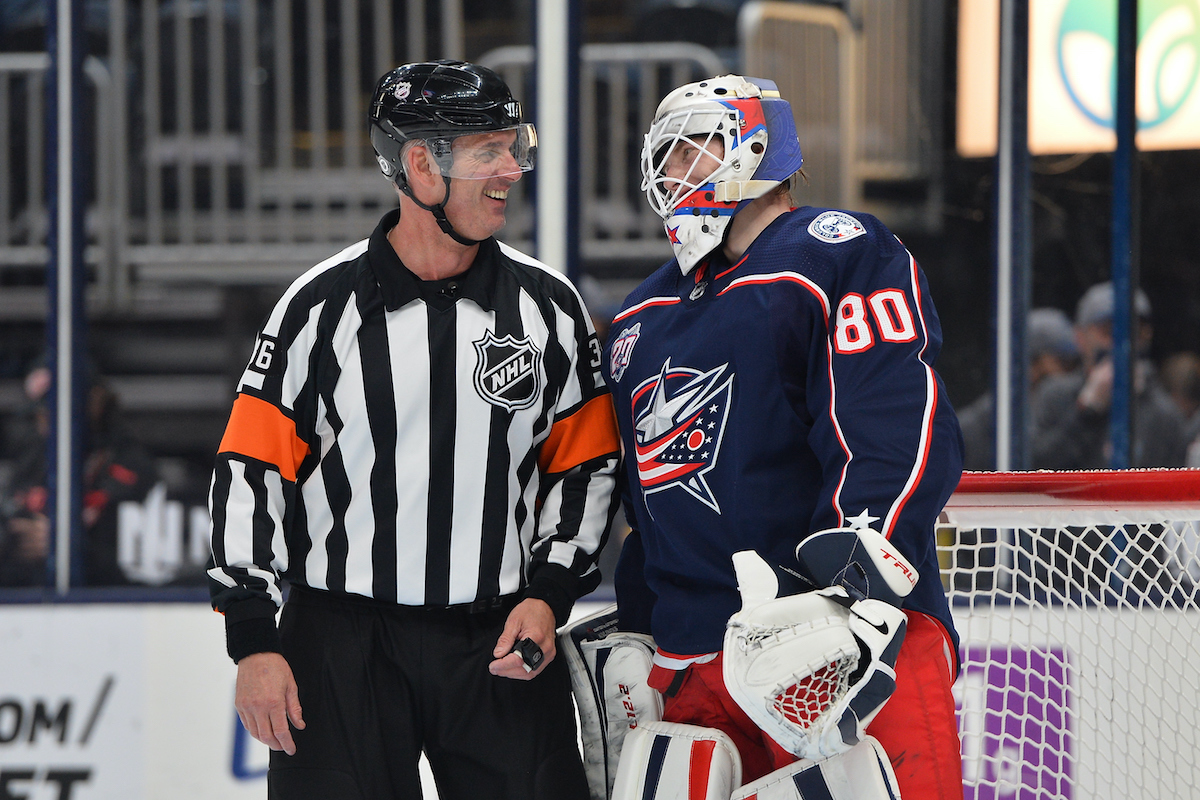 Referee Dean Morton and goaltender Matiss Kivlenieks of the Columbus Blue Jackets talk during a stoppage in play