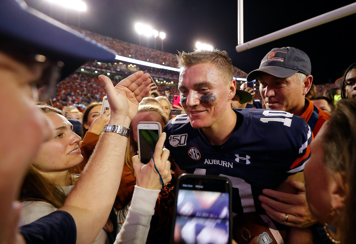 Bo Nix of the Auburn Tigers celebrates their 48-45 win over the Alabama Crimson Tid