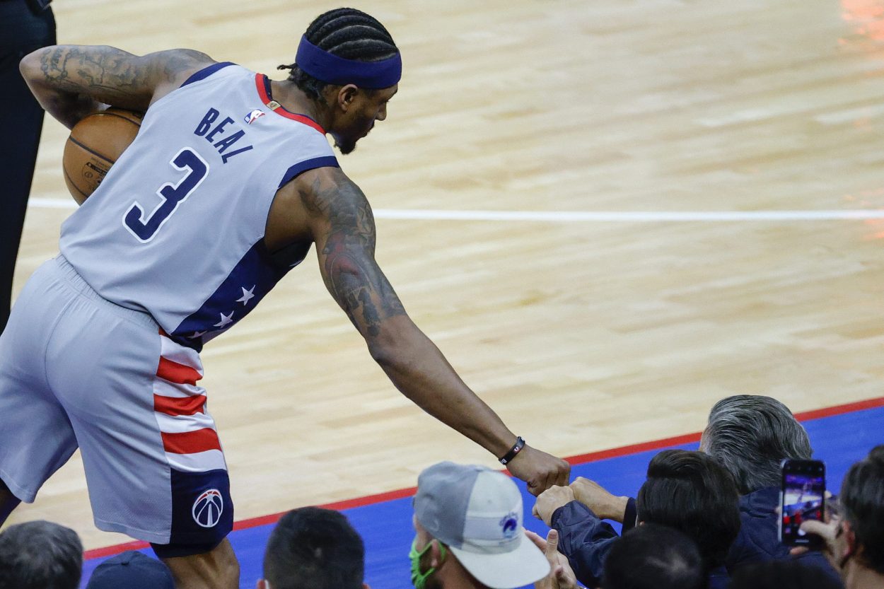 Washington Wizards guard Bradley Beal daps up a fan during an NBA playoff game.