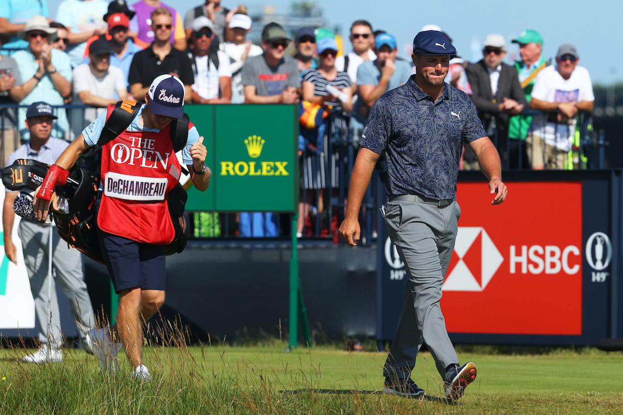 Bryson DeChambeau of the USA walks off the second tee with his caddie Brian Zeigler after playing his tee shot during Day Four of The 149th Open at Royal St George’s Golf Club on July 18, 2021 in Sandwich, England.