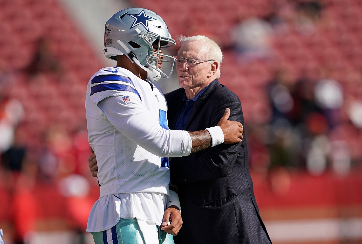 Quarterback Dak Prescott embraces Dallas Cowboys owner Jerry Jones before a game.