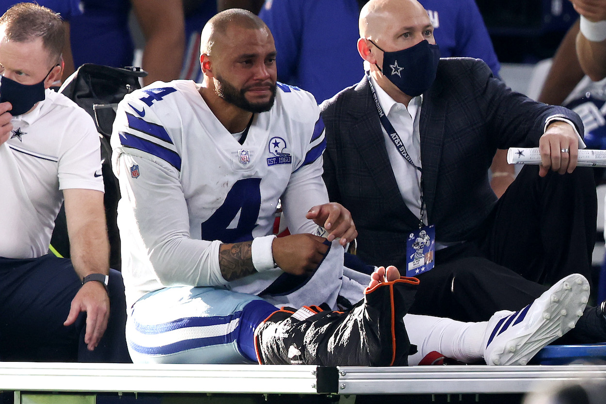 Dak Prescott of the Dallas Cowboys is carted off the field after sustaining a leg injury against the New York Giants during the third quarter at AT&T Stadium on October 11, 2020 in Arlington, Texas.
