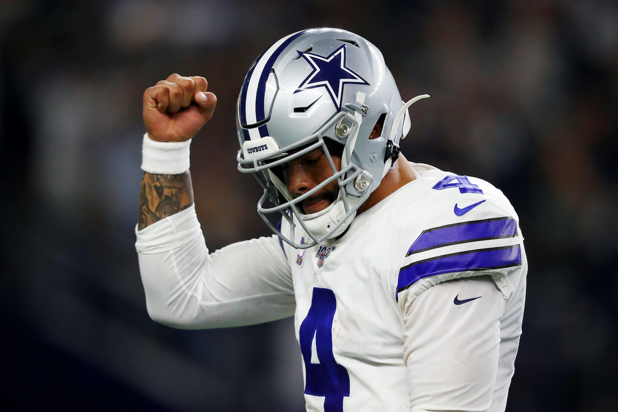 Dak Prescott of the Dallas Cowboys, whose Mississippi State Bulldogs baseball team won the school's first national championship at the 2020 College World Series, celebrates a first quarter touchdown against the Philadelphia Eagles in the game at AT&T Stadium on October 20, 2019 in Arlington, Texas.