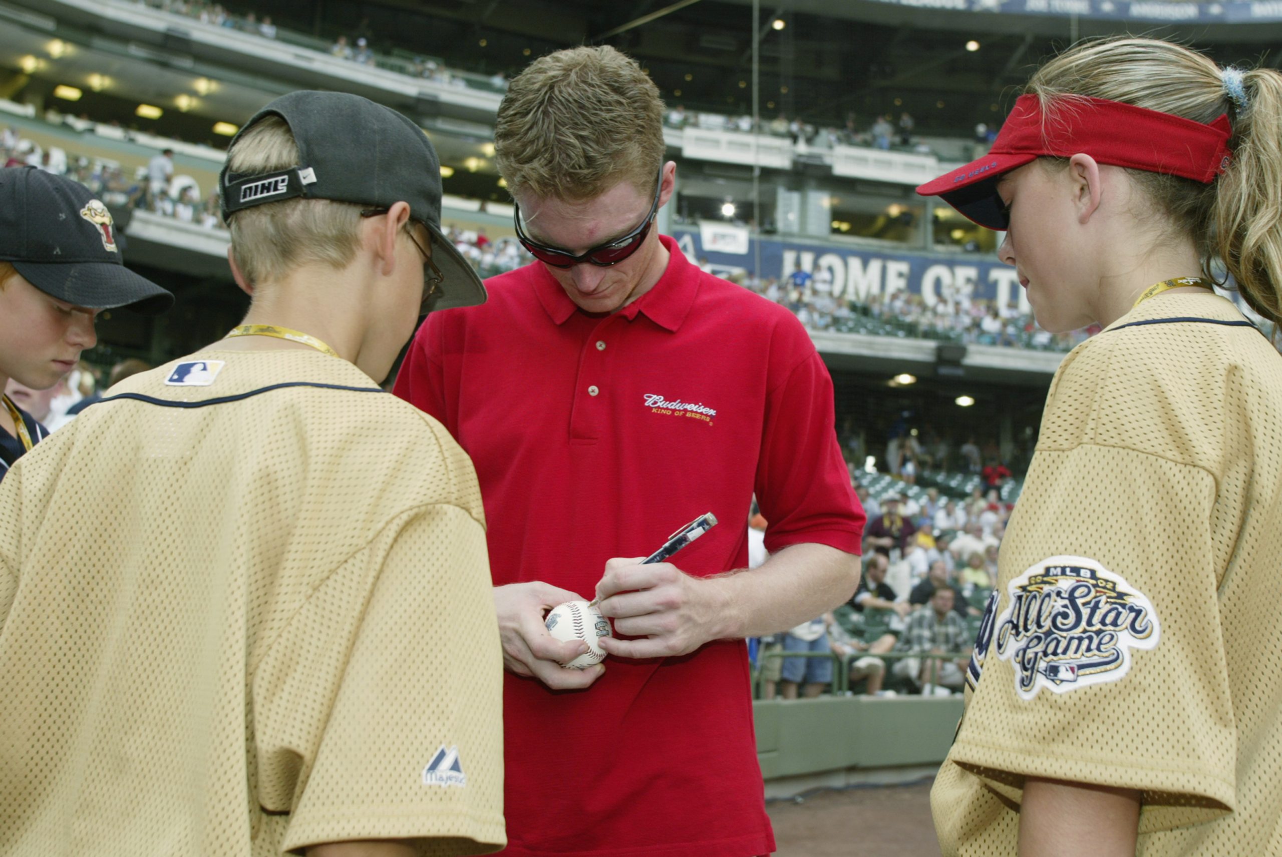 Dale Earnhardt Jr. signs autographs before the MLB All-Star Game Home Run Derby on July 8, 2002.