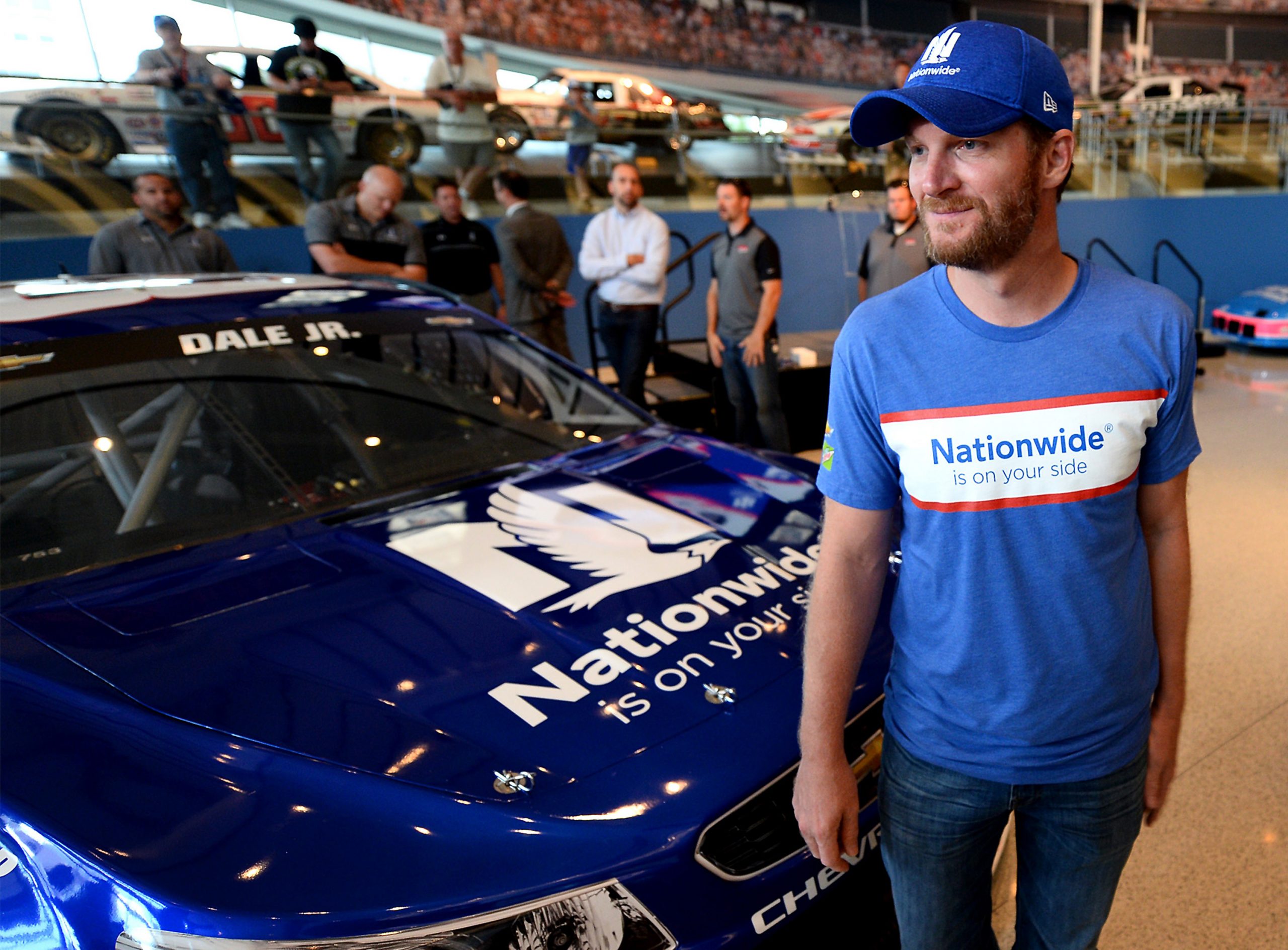 Dale Earnhardt Jr. walks past the No. 88 Nationwide Chevrolet that he drove in 2017.