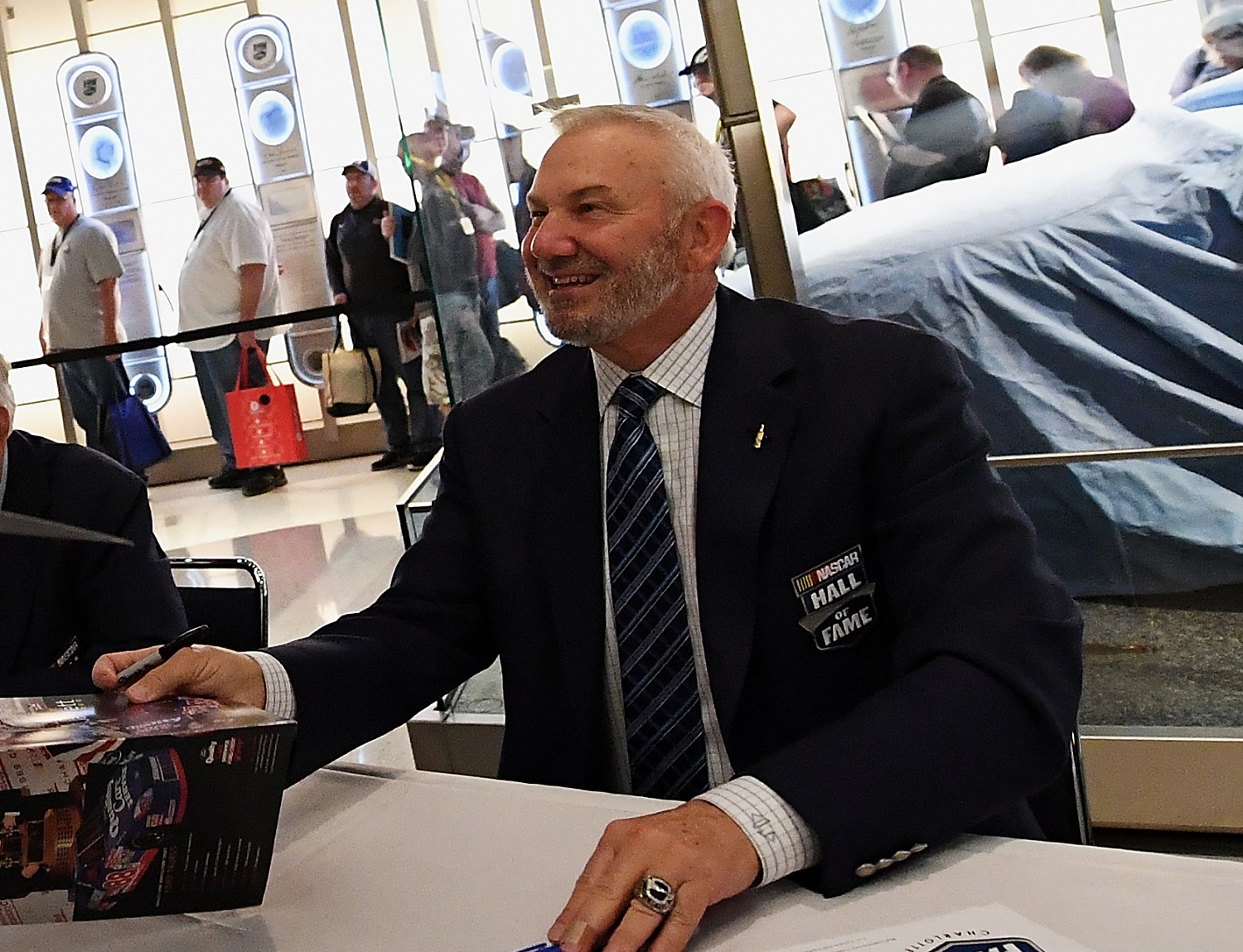 Dale Jarrett signs autographs at NASCAR Hall of Fame. Jarrett's father, Ned, is a fellow inductee in the Hall in Charlotte, North Carolina. | Mike Comer/Getty Images
