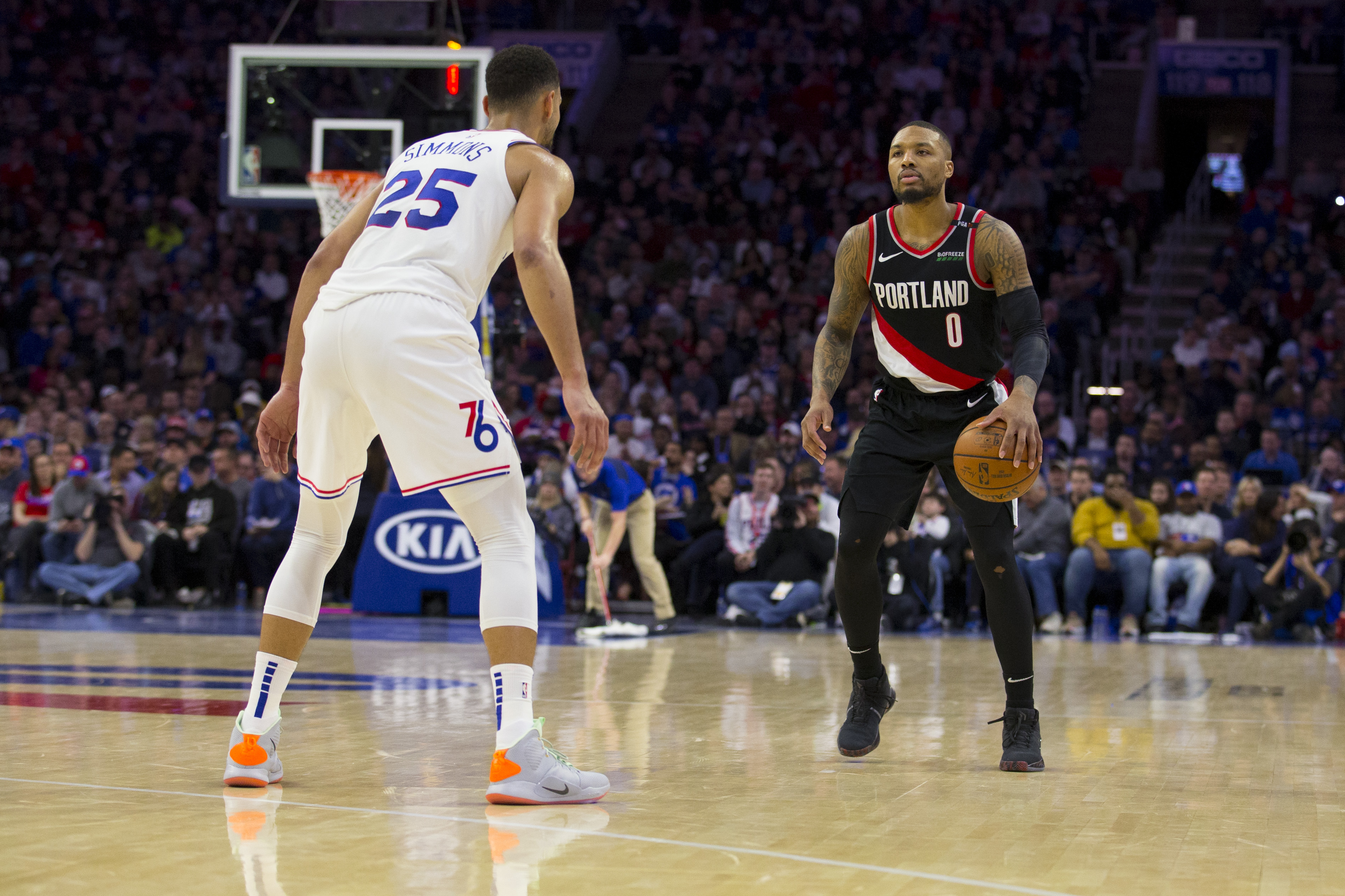 Philadelphia 76ers guard Ben Simmons defends Portland Trail Blazers star Damian Lillard during a game in 2019