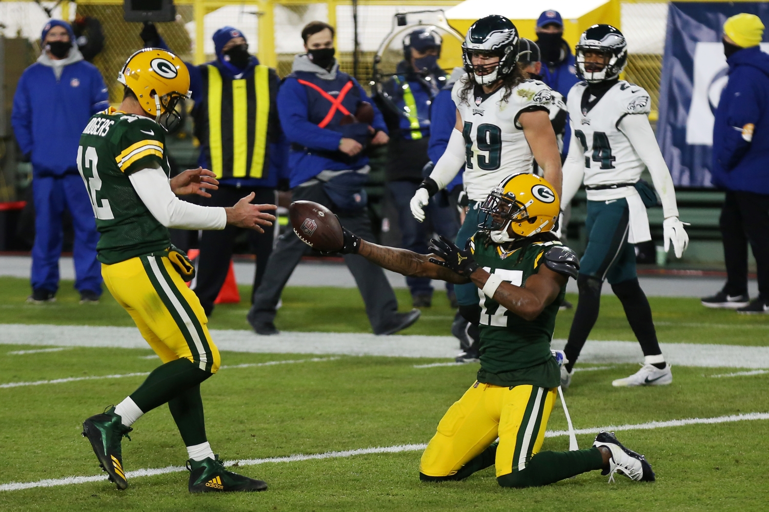 Packers WR Davante Adams hands the ball to Aaron Rodgers after scoring a touchdown.