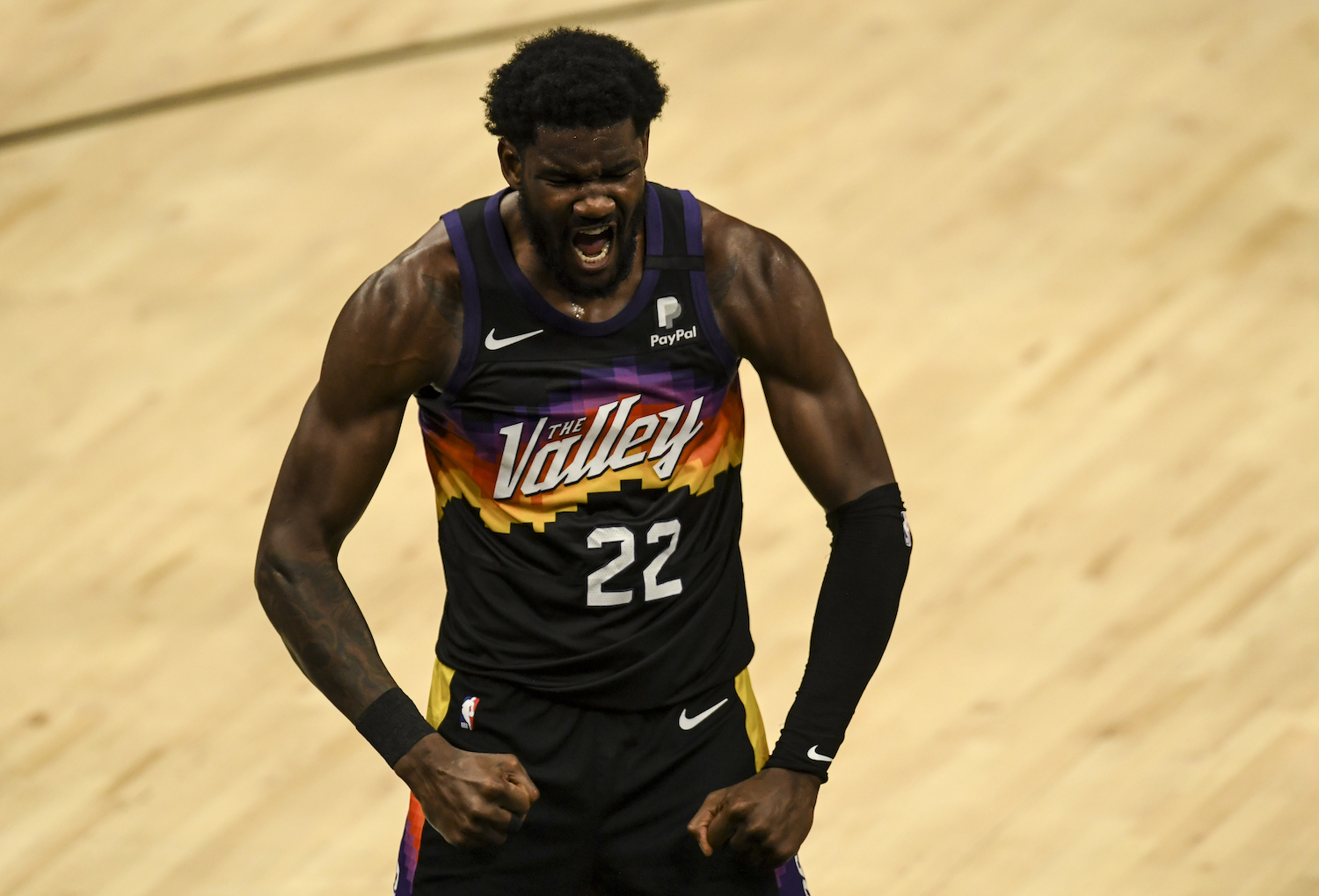 Phoenix Suns big man Deandre Ayton flexes after drawing a foul.