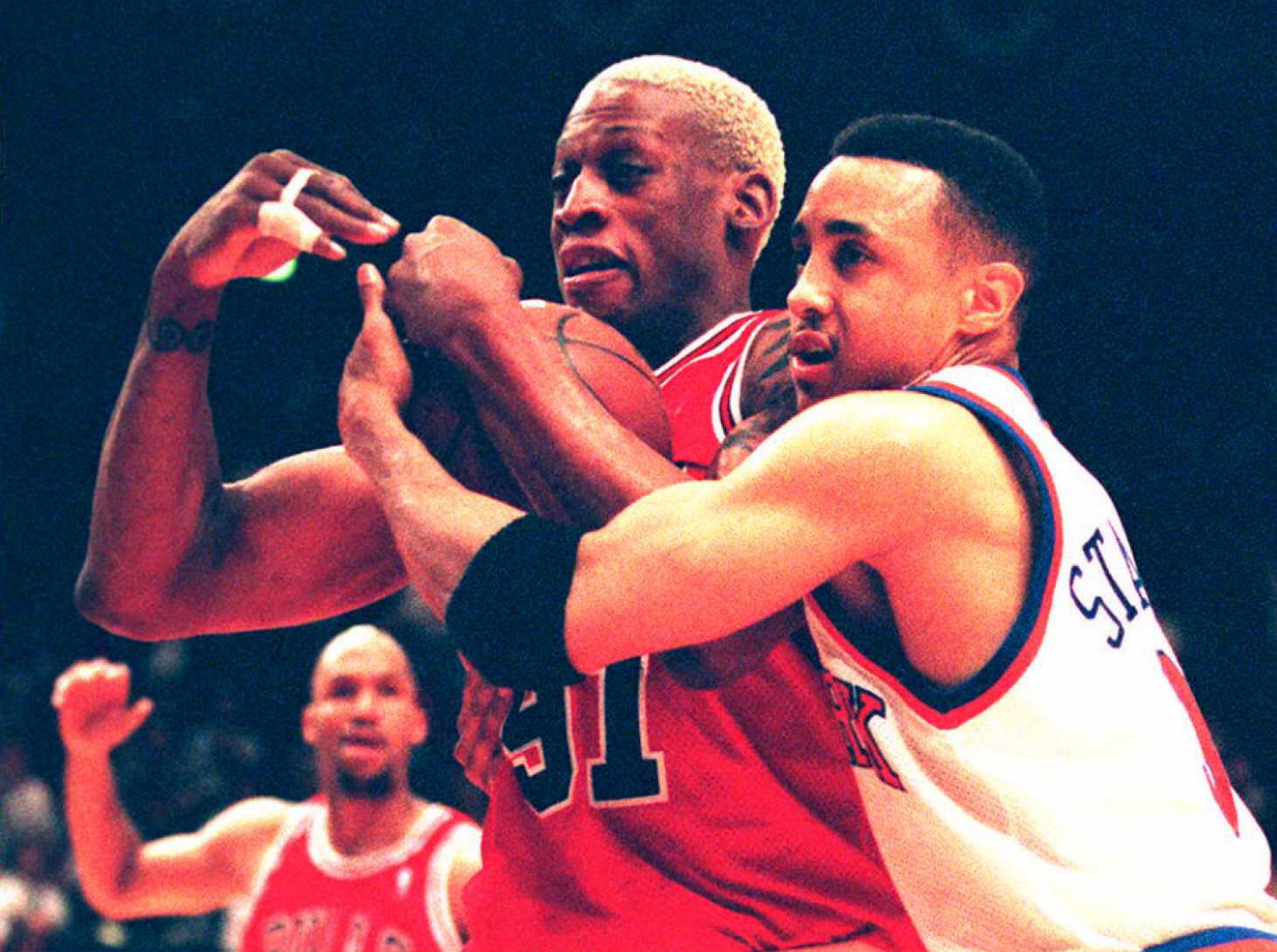 Dennis Rodman of the Chicago Bulls calls time out after his rebound.