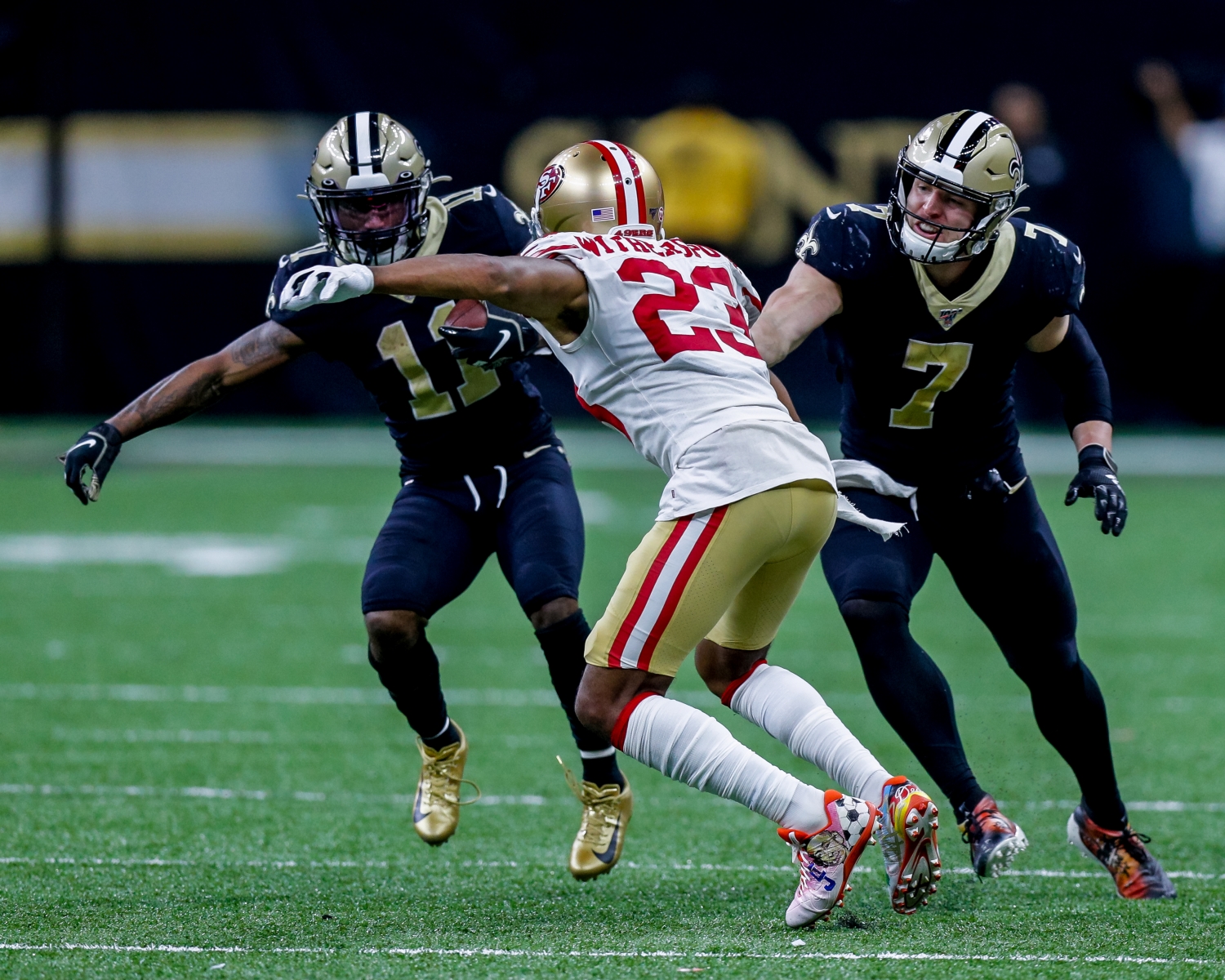 San Francisco 49ers cornerback Ahkello Witherspoon breaks from the block of New Orleans Saints quarterback Taysom Hill to tackle wide receiver/returner Deonte Harris.