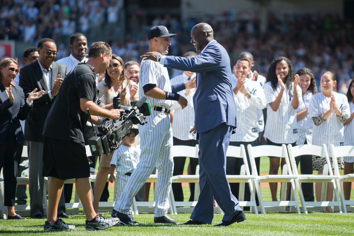 Derek Jeter of the New York Yankees is greeted by NBA Hall of Famer Michael Jordan in 2014