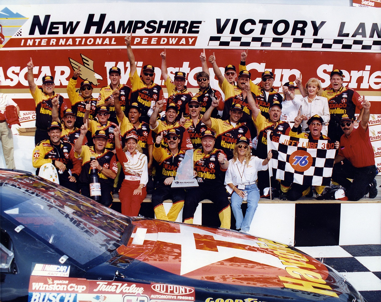 Ernie Irvan and his crew celebrate after winning the 1996 NASCAR Cup Series Jiffy Lube 300 at New Hampshire Motor Speedway